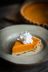 Pumpkin pie on rustic wooden background