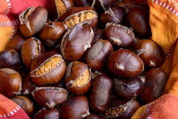 roasted chestnut inside a bowl with cloth napkin
