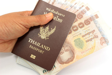Thai money and passport in man hand isolated on white