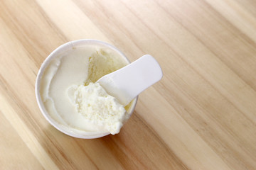 Ice cream with plastic spoon in paper cup