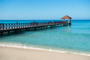 Long wooden jetty for ships, stretching into the sea