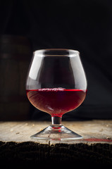 Glass white wine and bunch grapes on background of wooden 