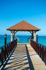 Wooden pontoon. Dock with canopy stretching into the sea