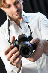 Fototapeta premium black camera in hands of a man