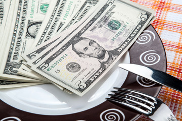 dollar bills on a plate