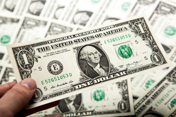 hand holds a dollar bill
