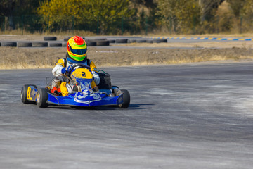 Karting - driver in helmet on kart circuit