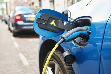 power supply plugged into an electric car during charging