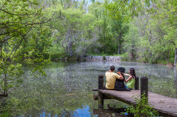 A couple and their dog enjoying the spring in a fantasy lake