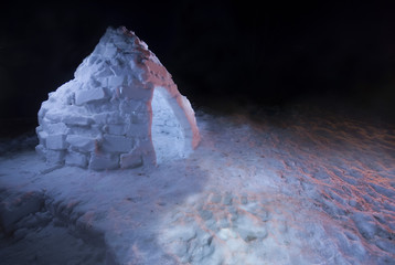 Homemade igloo lit up at night in front yard