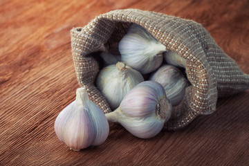 garlic in a bag on wooden table