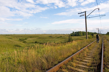 Fototapeta na wymiar A tourist disappears in the distance by rail, Ryazan region