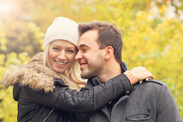 Fototapeta premium Young romantic couple in the park in autumn