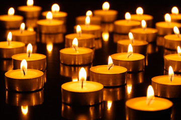 Many burning candles with shallow depth of field