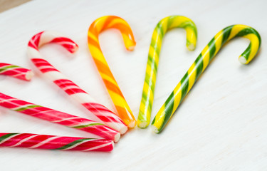 Christmas candy cane on a wooden background