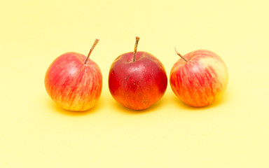 ripe apples on a yellow background