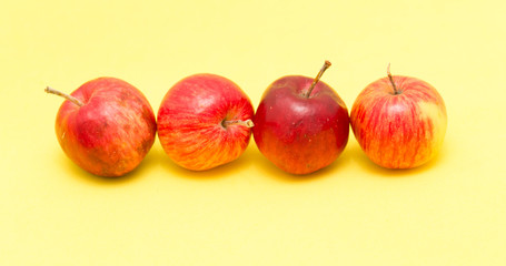 ripe apples on a yellow background