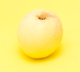 ripe apple on a yellow background