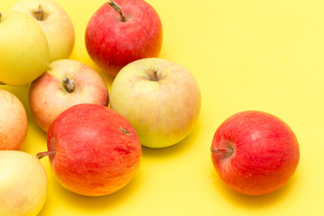 ripe apples on a yellow background