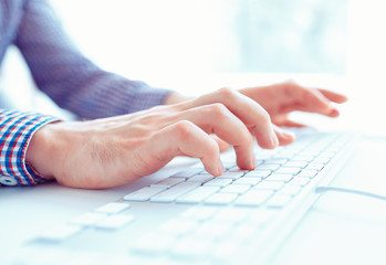Male hands or men office worker typing on the keyboard