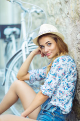 Happy woman with bicycle on street of old town