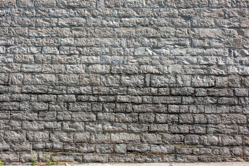 Hintergrund –Natursteinmauermit eckigen Steinen