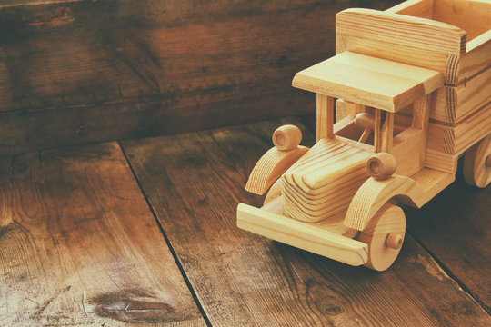 retro wooden toy car over wooden table. room for text. nostalgia and simplicity concept. retro style image
