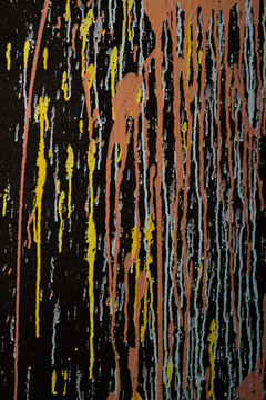 black background with colored paint splatter / drips