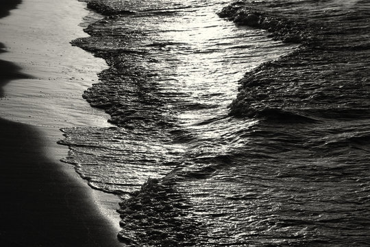 low key image of sea waves pattern, black and white.
