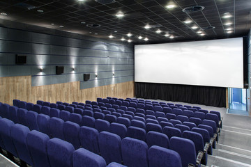 Interior cinema hall with plenty of seating and a big screen