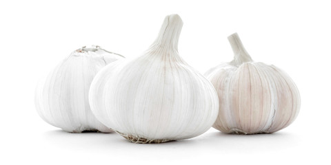 Three natural whole garlic bulbs isolated on white background