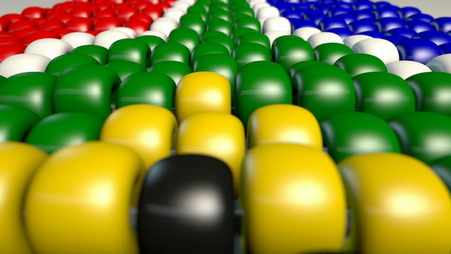 An extreme closeup pan of traditional zulu beaded south african flag on an isolated background