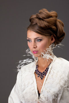Beautiful brown-haired woman with evening make-up, with amethyst