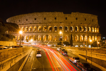 Fototapeta na wymiar Colosseum at night with colorful blurred traffic lights. Rome -