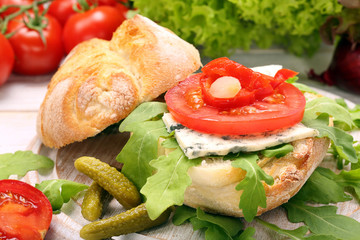 Vegetarian sandwich with blue cheese, arugula, marinated peppers
