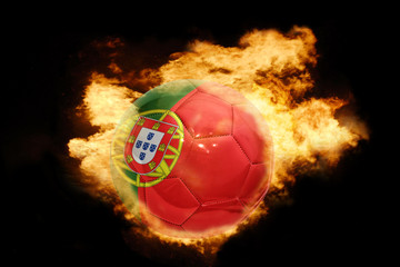 Fototapeta premium football ball with the flag of portugal on fire