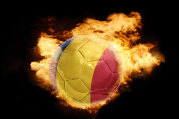 Fototapeta premium football ball with the flag of romania on fire