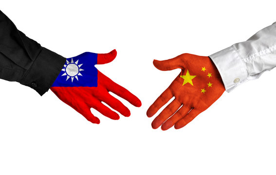 Taiwan and China leaders shaking hands on a deal agreement