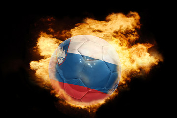 Fototapeta premium football ball with the flag of slovenia on fire