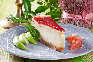 cheesecake with jelly and strawberry slices on a plate close-up for the menu