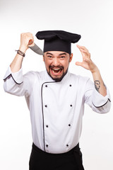  handsome cook in uniform and hat gesturing with  big  knife