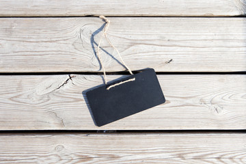 Black signboard on wooden background