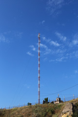 communication tower against the blue sky