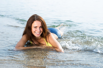 girl in a bathing suit lying in the sea