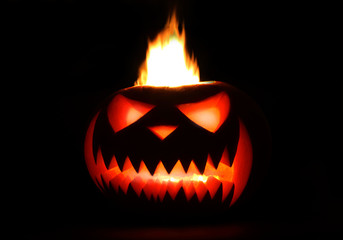 Fototapeta premium Burning Halloween Pumpkin in the darkness