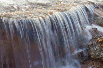 Fototapeta na wymiar Blurred stream waterfall.