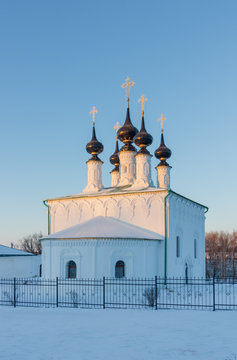 Winter landscape in the early frosty morning in Suzdal with ancient temples. Entrance to Jerusalem church 