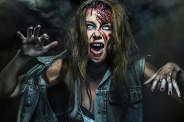 Fotobehang Close-up portrait of horrible zombie woman. Horror. Halloween. © Mike Orlov