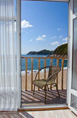 View through an open door of the sea sunny summer day.