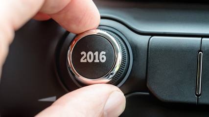 Man turning a dial or electronic control knob with the date 2016
